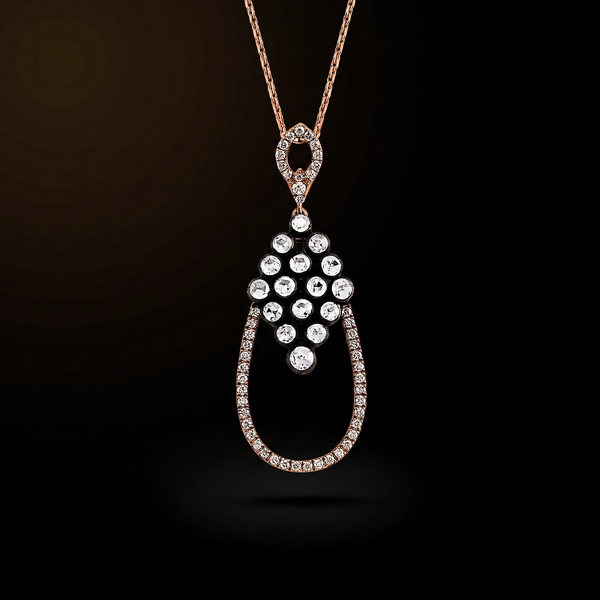 The Dewdrop Necklace in close view, a rose cut diamond cascade in an open teardrop on a rose gold chain