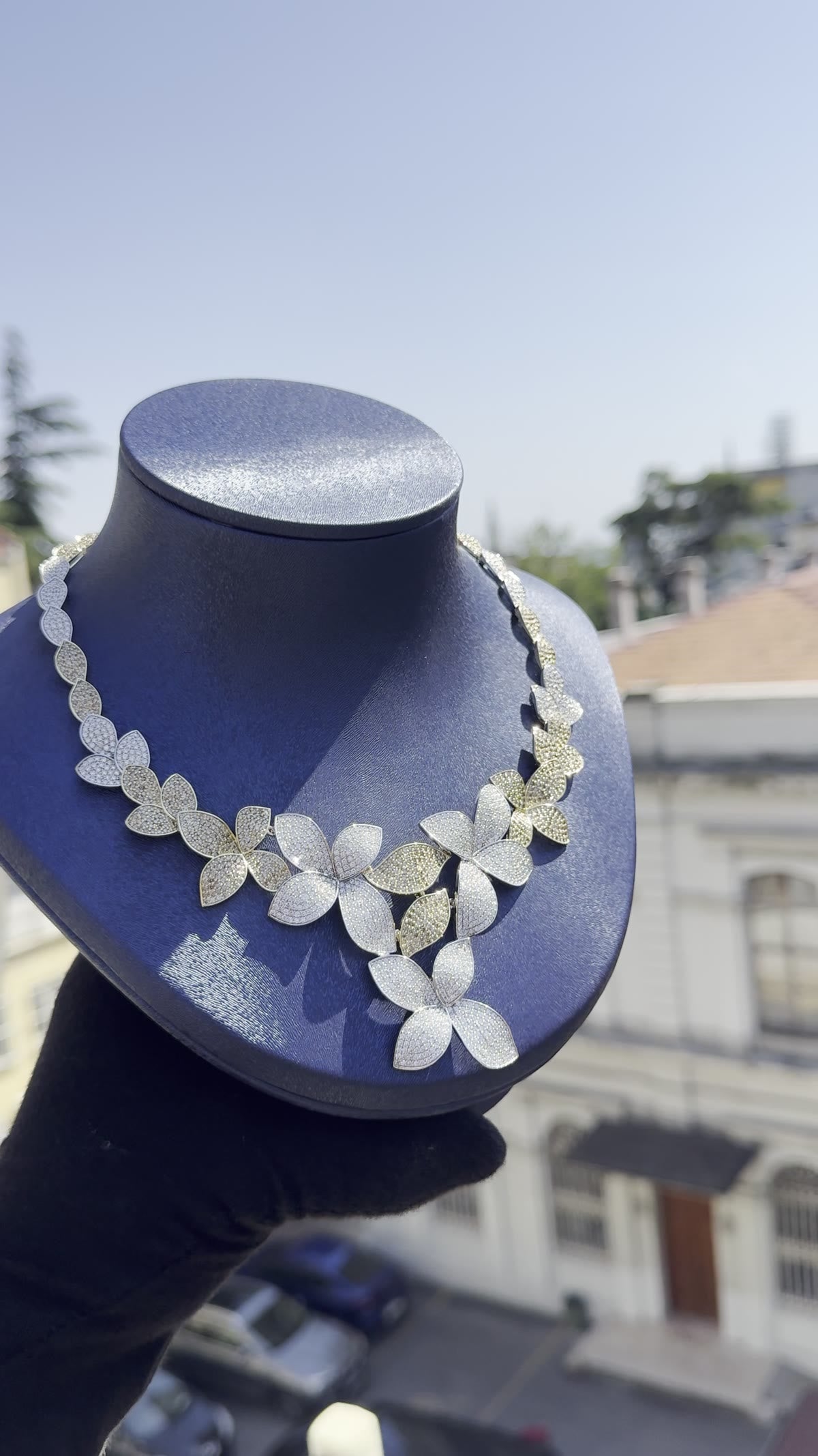 Pav&eacute; leaf necklace on a velvet bust against the Istanbul skyline